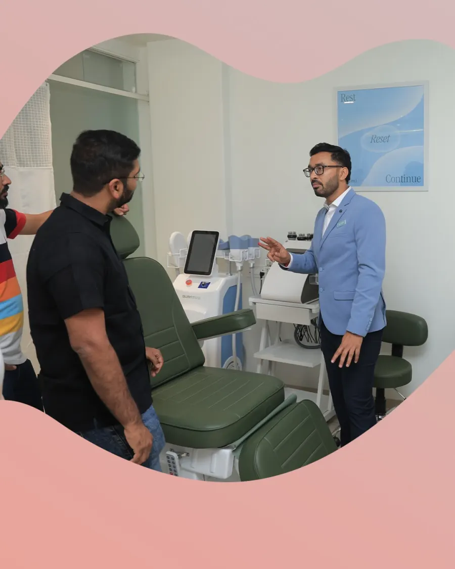 Dr. Dhrumit Gohil explains a treatment device to guests